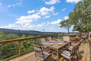 a table and chairs on a deck with a view at Resting on the Ridge in Beech Mountain