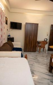 a living room with a couch and a wooden cabinet at Ebenezer Stay in Trivandrum