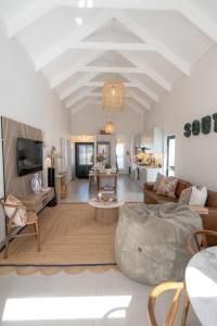 a living room with a couch and a table at Sout Huijs Langebaan with hot tub in Langebaan
