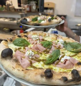 two pizzas sitting on top of a table at Guesthouse Locanda Regina Sofia in Bologna