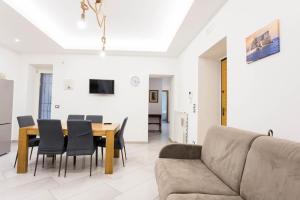 a living room with a couch and a table and chairs at Victoria House Pompei in SantʼAntonio Abate