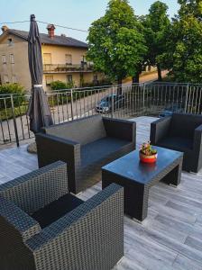 a patio with two chairs and a table and an umbrella at Apartma PERIN in Dobrovo +2 photos