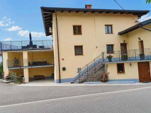 a large yellow building with stairs on the side of it at Apartma PERIN in Dobrovo