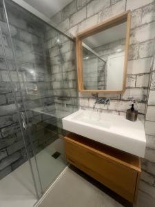 a bathroom with a sink and a mirror and a shower at Tavira Central Harmony in Tavira +11 photos