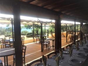a restaurant with tables and chairs on a patio at Villetta Indipendente Sardegna in Villaputzu