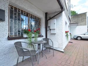 a patio with a table and chairs and a window at Pokoje u Małgorzaty in Międzyzdroje