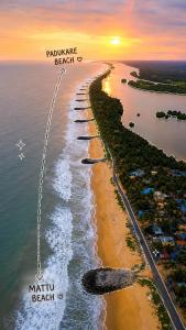 an aerial view of a beach at sunset at Mayura sea view in Malpe +5 photos