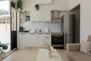 a kitchen with a refrigerator and a table in a room at Stella's Apartment in Karfas