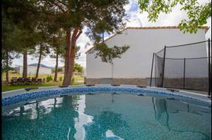 a swimming pool in front of a house at La Casa del Alcalde in Ceguilla
