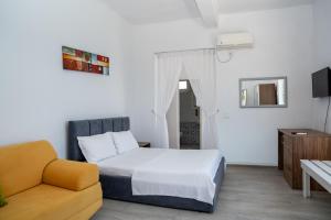 a bedroom with a bed and a couch at Hotel Riviera Dhermi in Dhërmi +95 photos