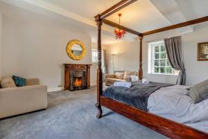 a bedroom with a four poster bed and a fireplace at Historic 6-Bed Manor near Shifnal, Parking in Shifnal