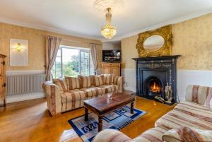 a living room with two couches and a fireplace at Historic 6-Bed Manor near Shifnal, Parking in Shifnal +12 photos