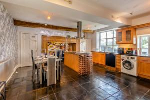 a kitchen with a table and a dining room at Historic 6-Bed Manor near Shifnal, Parking in Shifnal