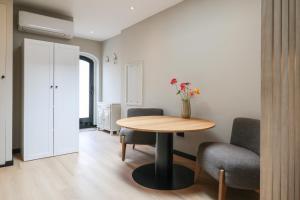 a room with a table and two chairs and a table at City Suite Sneek in Sneek