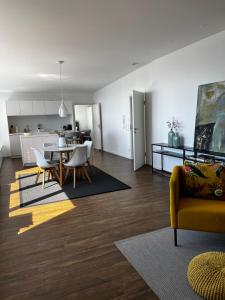 a living room and kitchen with a table and chairs at Kling am See in Friedrichshafen