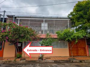 a building with aadobe entrance sign in front of it at Casa Liz in Managua