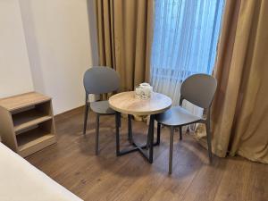 a small table and two chairs in a room at Тихий Замок Джал in Bishkek