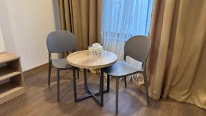 a table and two chairs with glasses on it at Тихий Замок Джал in Bishkek +41 photos