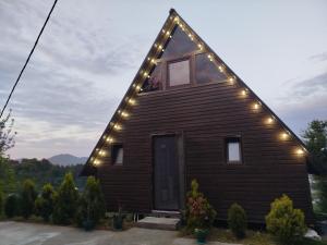 a house with lights on the side of it at Roinis Villa in T'khilnari +6 photos