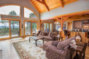 a living room with couches and a table at Ridgeline Cabin in Elk Park