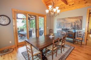 a dining room with a wooden table and chairs at Ridgeline Cabin in Elk Park +18 photos