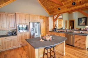a large kitchen with wooden cabinets and a large island at Ridgeline Cabin in Elk Park