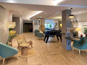 a living room filled with furniture and a piano at ibis Styles Rennes Cesson in Cesson-Sévigné