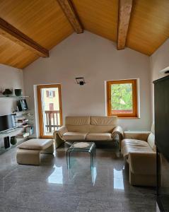 a living room with a couch and a coffee table at Cà ai Camòss, DUPLEX deluxe - centro paese in San Bernardino +22 photos