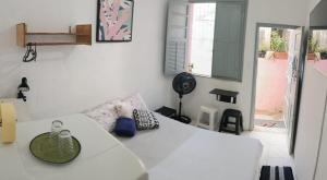 a living room with a white table and a couch at Rio Private Budget Suite & Easy Transport Access in Rio de Janeiro