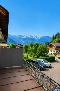 a balcony with cars parked in a parking lot at All'antica Birreria in Predazzo