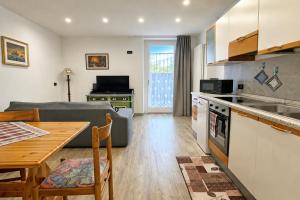 a kitchen and living room with a couch and a table at All'antica Birreria in Predazzo