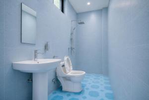 a white bathroom with a sink and a toilet at Cape Town K Hotel in Kigali +19 photos