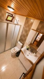 a bathroom with a toilet and a sink at Cirali Camping in Cıralı