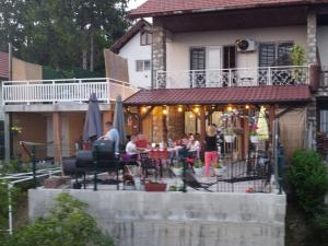 a group of people standing outside of a house at Vikendica Dania in Tuzla