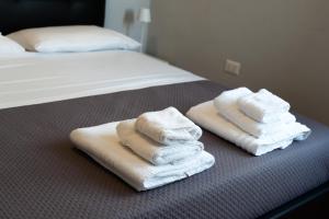 two stacks of towels sitting on top of a bed at Central Viale in Telese