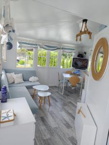 a living room with a couch and a table at Biały domek in Zastań