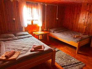 a bedroom with two beds and a window at Ljubav Stara Zaovine in Lazići