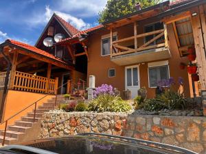 a house with stairs and flowers in front of it at Ljubav Stara Zaovine in Lazići