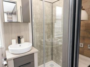 a bathroom with a shower and a sink at Hollybirch in Crieff +19 photos