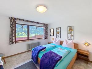 a bedroom with a large bed and a window at Apartment Höllwarth by Interhome in Fügenberg