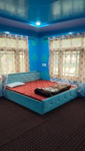 a large bed in a room with two windows at Samoon guest house in Wāmpor