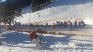 モジリェにあるApartmaji Golob-Golteの雪上スキー場の乗り場に座る者