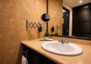 a bathroom with a sink and a mirror at Hotel Clara Luna in Xalapa +24 photos