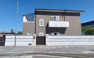 a house with a white fence in front of it at 50 Special in Pontedera