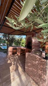 an outdoor patio with a brick fireplace and a wooden deck at Dar Julia in Sousse