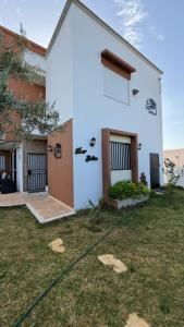 a white house with a yard in front of it at Dar Julia in Sousse