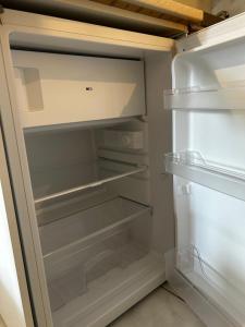 an empty refrigerator with its door open in a kitchen at Anna rooms ANTHOS GROUP in Nea Vrasna +12 photos