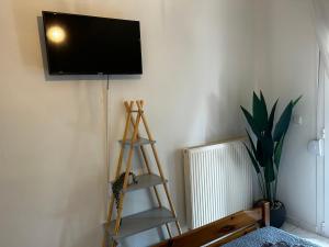 a living room with a flat screen tv on a wall at Anna rooms ANTHOS GROUP in Nea Vrasna
