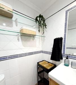 a white bathroom with a sink and a mirror at Apartamento SOLYMAR Chipiona in Chipiona +25 photos