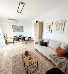 a living room with a couch and a table at Apartamento SOLYMAR Chipiona in Chipiona